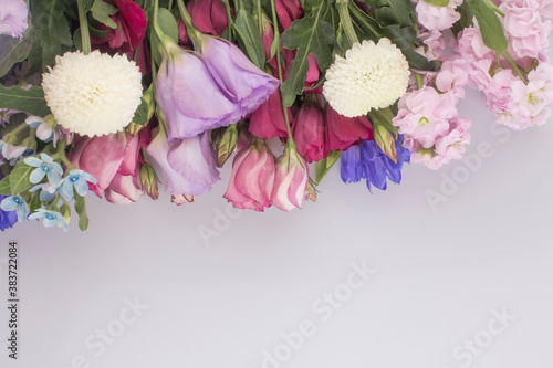 bouquet of pink and violet lisianthus flowers on white background.