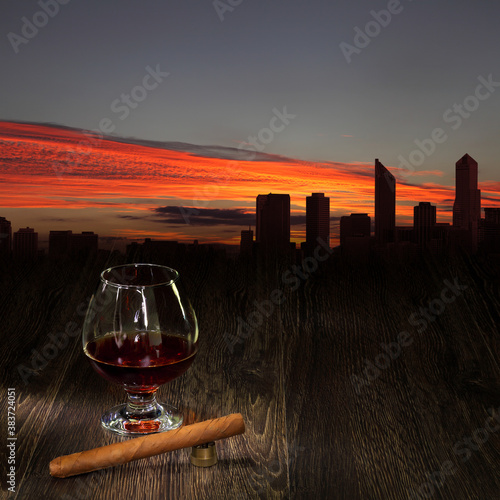 Glass of cognac and sigar photo