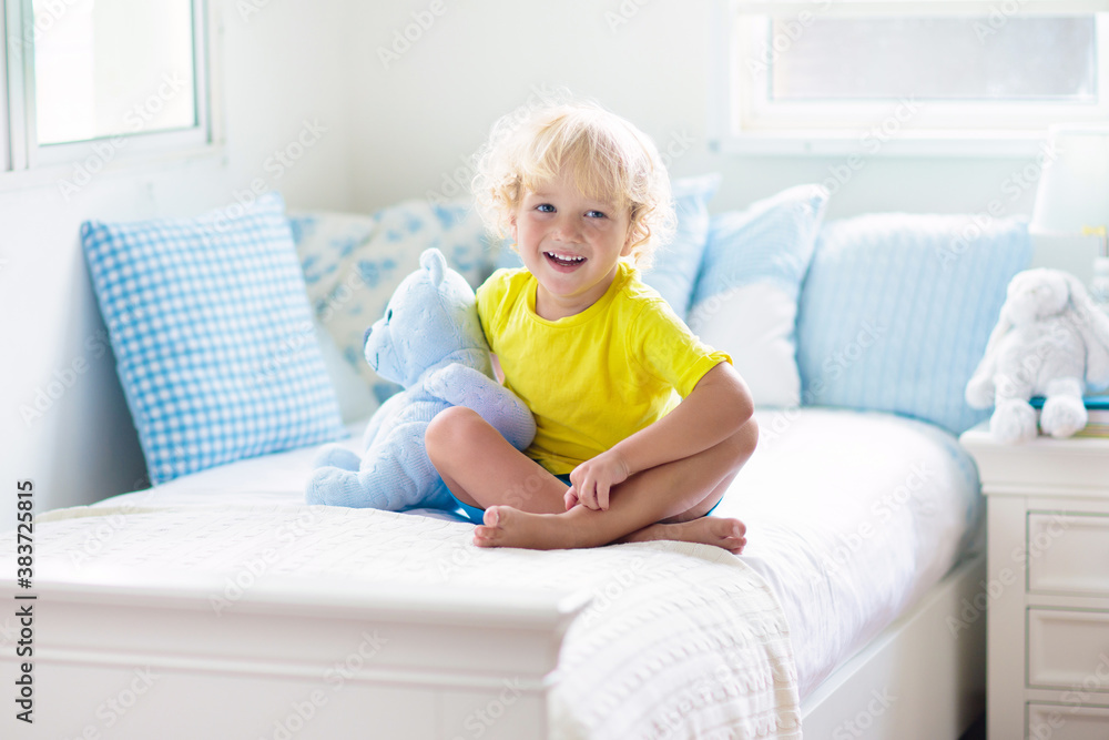Child playing in bed. Kids room. Baby boy at home. Child playing in bed. Kids room. Baby boy at home.