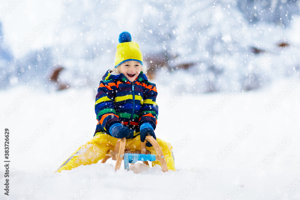 Boy on sled ride. Child sledding. Kid on sledge Boy on sled ride. Child sledding. Kid on sledge