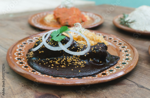 mole with chicken and rice, food with traditional Mexican sauce and sesame seeds