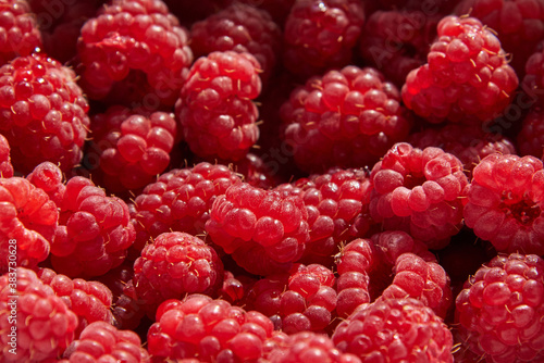 Fresh juicy ripe raspberry fruit, close-up, background.