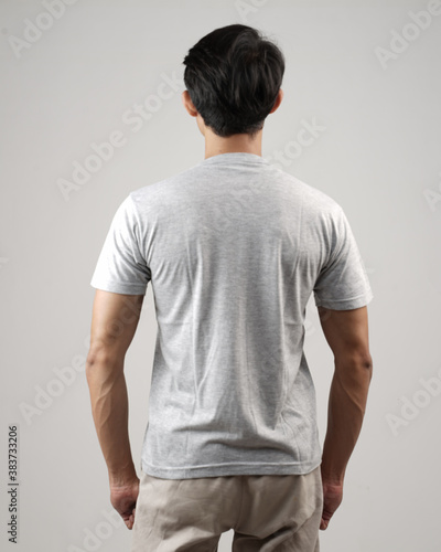 Young men in empty gray T-shirts and wearing health masks, dress up and pose like famous T-shirt models. Men's t-shirt template and mockup design for print.