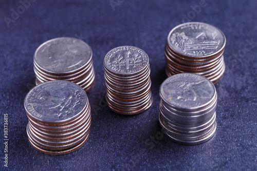 American coins and us dollars on a black table