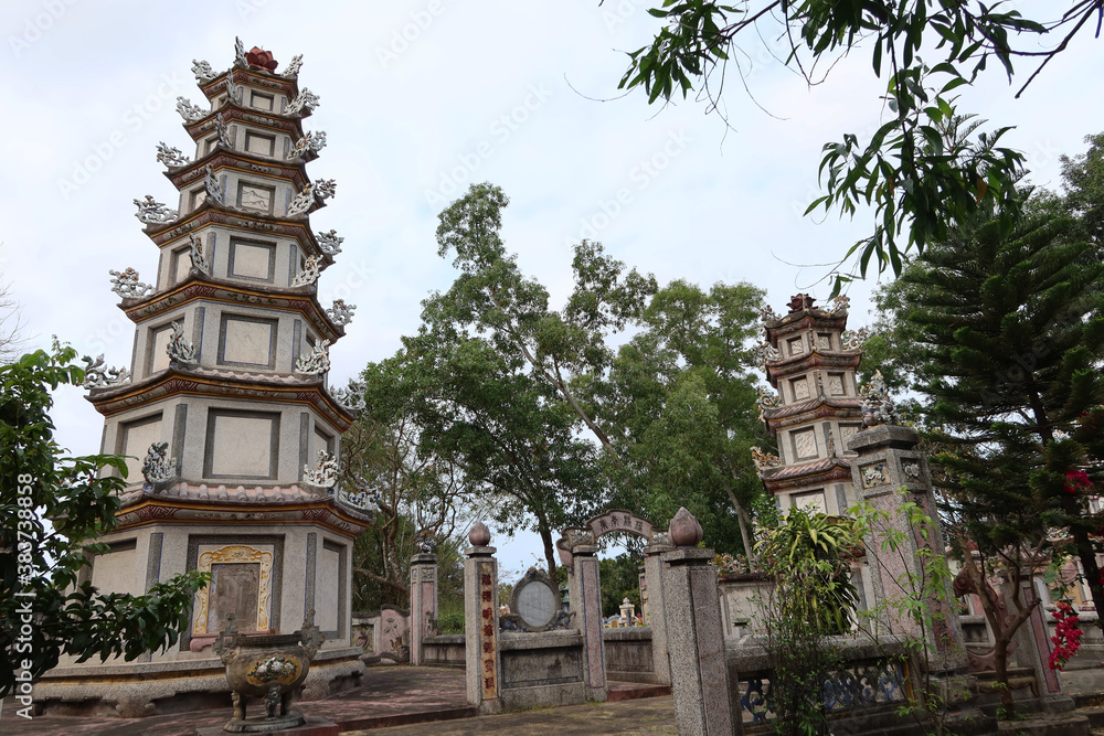 Hoi An, Vietnam, March 3, 2020: Multi-story pagodas in the gardens of the Chùa Chúc Thánh temple. Hoi An, Vietnam