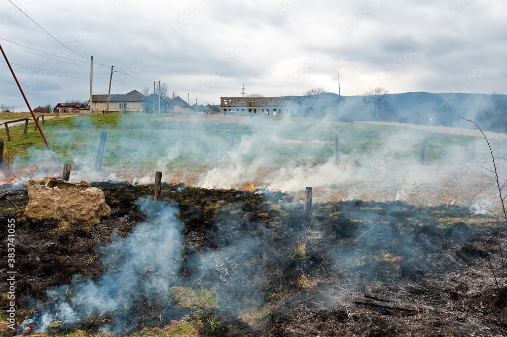 Spring arson of a grass in countryside in Ukraine
