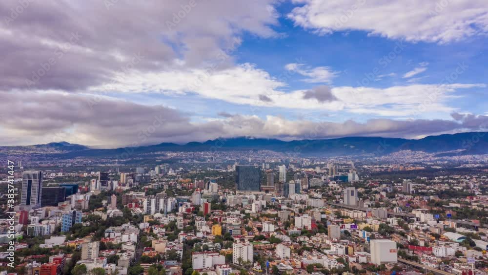 Flying over Mixcoac in Mexico City with clouds rolling over Ajusco Mountains Flying over Mixcoac in Mexico City with clouds rolling over Ajusco Mountains