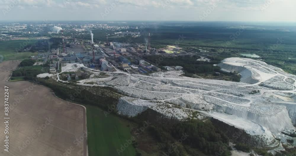 Mining and processing plant, view of mineral piles, mountains of minerlas and sand, view from height, mininпg of minerals to create chemical products. Mining and processing plant, view of mineral piles, mountains of minerlas and sand, view from height, mininпg of minerals to create chemical products.