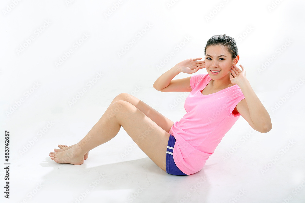 beautiful young south east Asian Chinese woman exercise workout sit ups look at camera on white background beautiful young south east Asian Chinese woman exercise workout sit ups look at camera on white background
