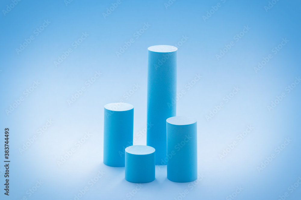 High cylindrical podiums on pastel blue background. Empty showcase design mockup for promotion sale, presentation of cosmetic products, seasonal and holiday discounts. 3D chart or graph High cylindrical podiums on pastel blue background. Empty showcase design mockup for promotion sale, presentation of cosmetic products, seasonal and holiday discounts. 3D chart or graph
