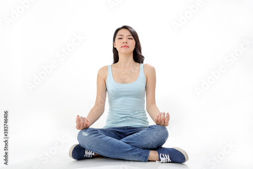 Beautiful young south east Asian Chinese woman yoga workout exercise on white background