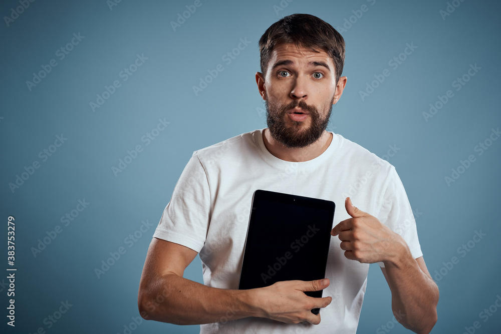 A guy with a tablet on a blue background and in a white T-shirt sensor Monitor Model A guy with a tablet on a blue background and in a white T-shirt sensor Monitor Model