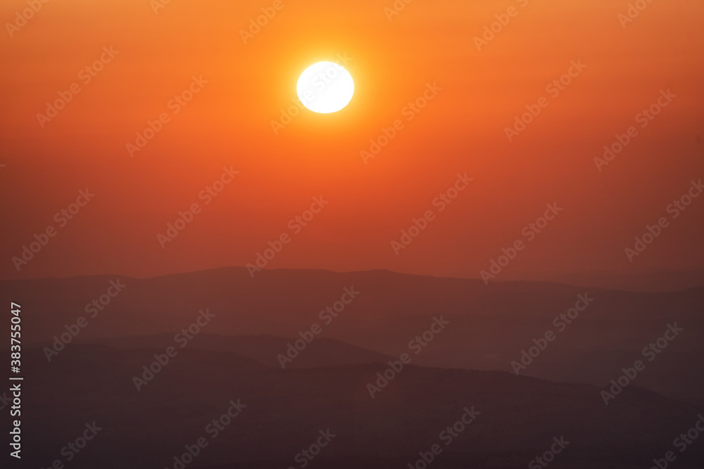 Beautiful big sunset over sea. Tranquil scene of Closeup red sun and red sky sunset Beautiful big sunset over sea. Tranquil scene of Closeup red sun and red sky sunset