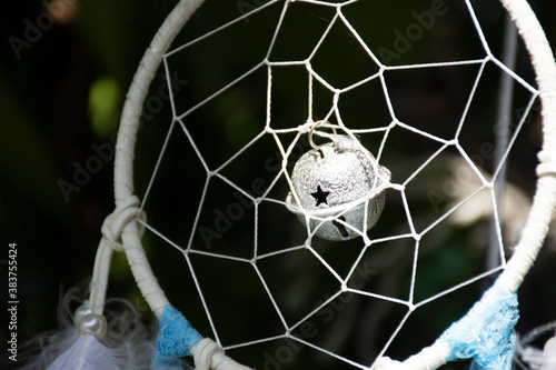 Movement from wind Handmade dream catcher or dreamcatcher hanging on tree in garden of house in Nonthaburi, Thailand photo