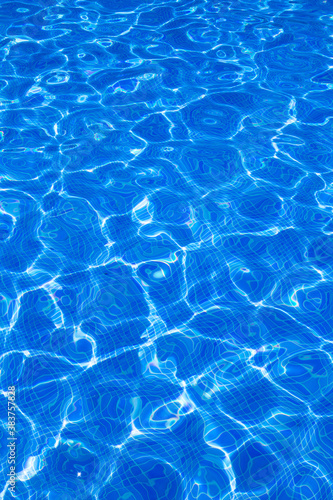 Blue tiels pool with ripple water reflection photo