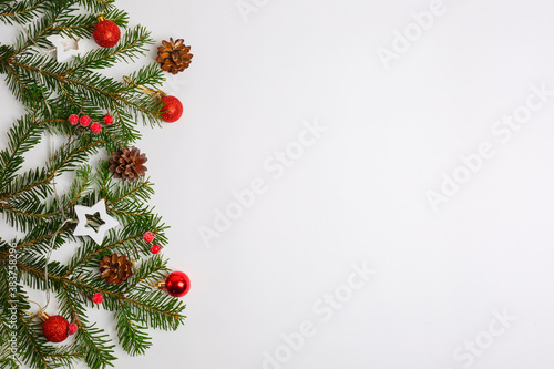Christmas background, Christmas tree branches red Christmas toys cones ,garland, place for text