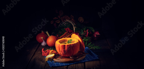 Delicious autumn pumpkin soup with baguette photo