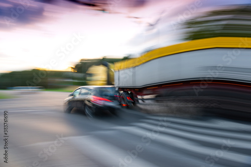 Dangerous city traffic situation with a car and a truck in motion blur