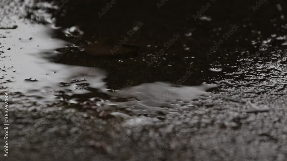 Rain water drops dripping onto the concrete floor until it becomes waterlogged Rain water drops dripping onto the concrete floor until it becomes waterlogged