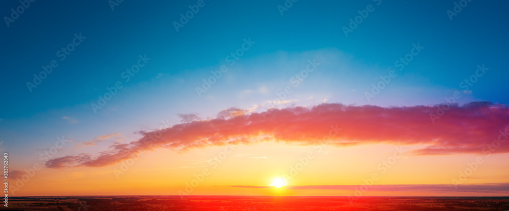 Colorful cloudy sky at sunset over the countryside. Gradient color. Colorful cloudy sky at sunset over the countryside. Gradient color.