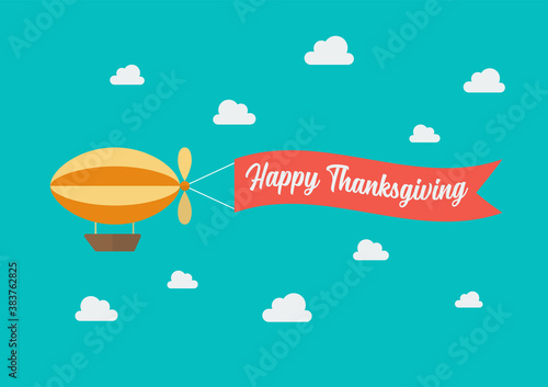 Airship pulls the banner with word Happy Thanksgiving on it