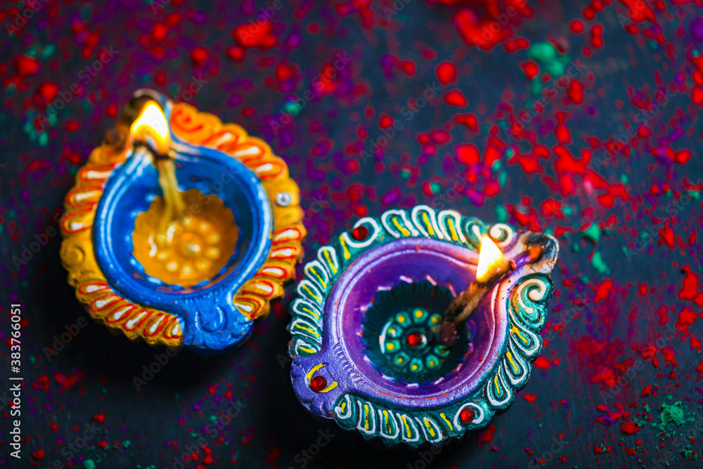 Fototapeta premium Diwali Diya with Fire Crackers over rangoli background