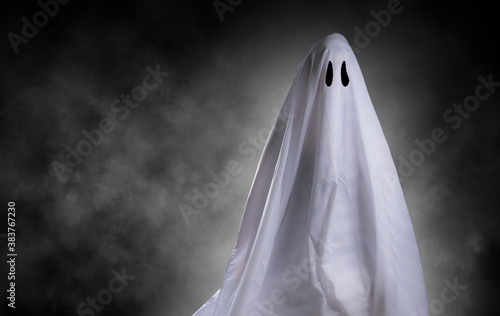 Scary white ghost at big eye for Halloween concept with clipping path