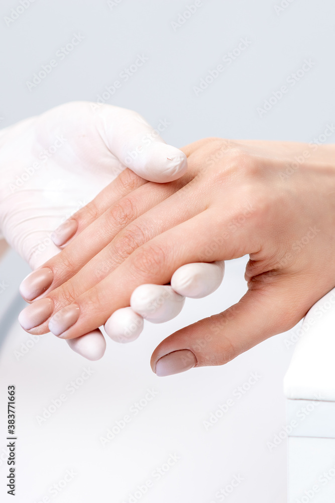 Female hand after manicure in hand of manicure master at nail salon Female hand after manicure in hand of manicure master at nail salon