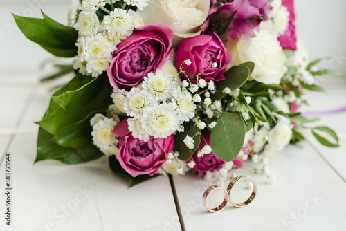 bouquet of pink roses  bridal bouquet of roses  bridal bouquet with wedding rings  wedding rings