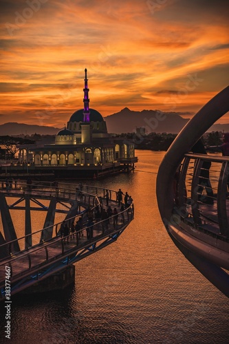 The floating mosque of Kuching and The Darul Hana Bridge during sunset photo