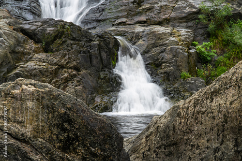 Waterfall stream flow with rock. Klong nam lai waterfall in Kamphaeng Phet  Thailand. Slow speed shutter concept.