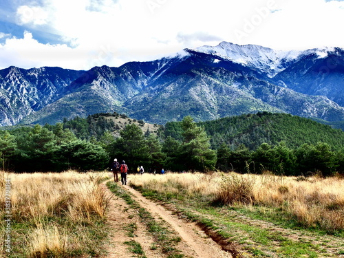 couple de randonneurs en montagne qui marchent sur un sentier © Ourson+