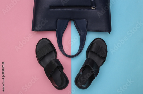Women's leather sandals and bag on pink-blue pastel background. Women's accessories. Top view. Flat lay