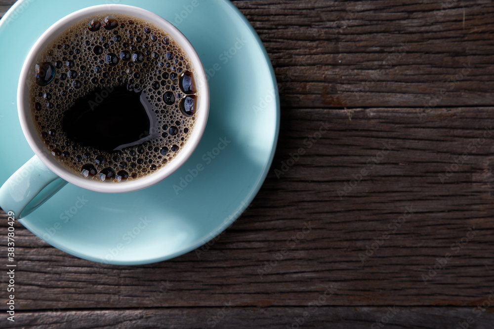 Coffee cup with black coffee on wooden table, top view Coffee cup with black coffee on wooden table, top view