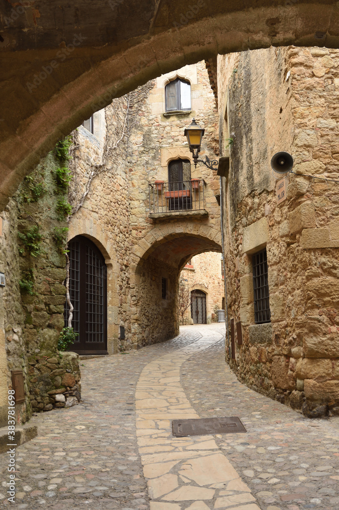 arch and street of the old town of medieval village of Pals, Girona province, Catalonia, Spain