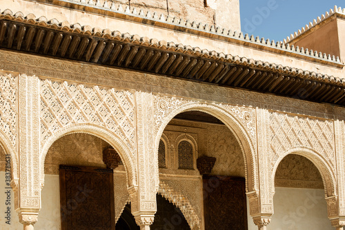 Beautiful architecture with an arch wooden door in the Moorish style at Nasrid Palace, Alhambra.