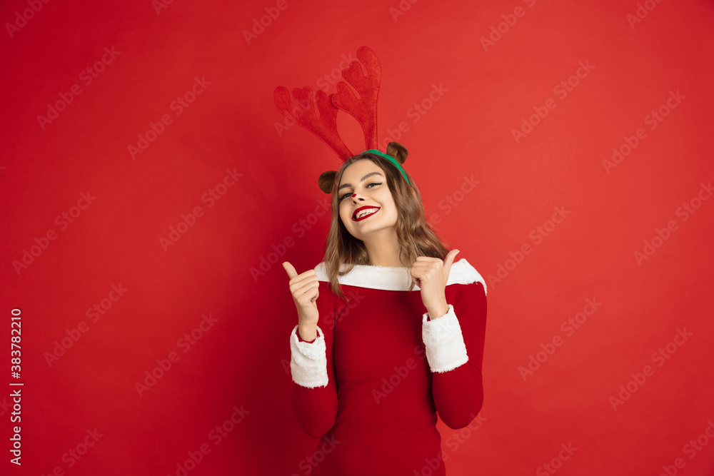 Pointing. Greetingcard. Concept of Christmas, 2021 New Year's, winter mood, holidays. Copyspace for ad, postcard. Beautiful caucasian woman with long hair like Santa's Reindeer catching giftbox. Pointing. Greetingcard. Concept of Christmas, 2021 New Year's, winter mood, holidays. Copyspace for ad, postcard. Beautiful caucasian woman with long hair like Santa's Reindeer catching giftbox.