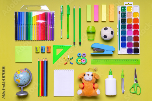 Back to school. Office supplies and goods for creativity on yellow green pastel background. Kids school items, toys and stationery. Education concept photo