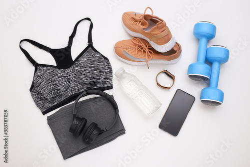 Flat lay composition of Sports equipment, clothes on white background. Fitness, sport and healthy lifestyle concept. Top view