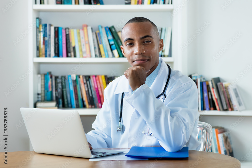 Serious african american male doctor at computer Serious african american male doctor at computer