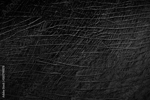 Abstract dark black scratched cement wall texture background.