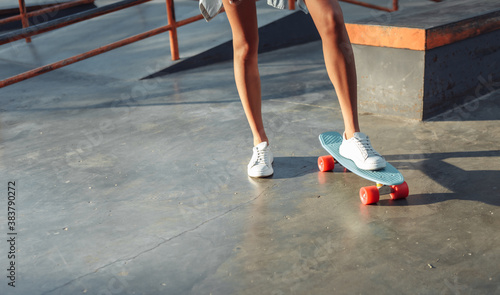 Crop photo of female skater with cruiser board at skatepark