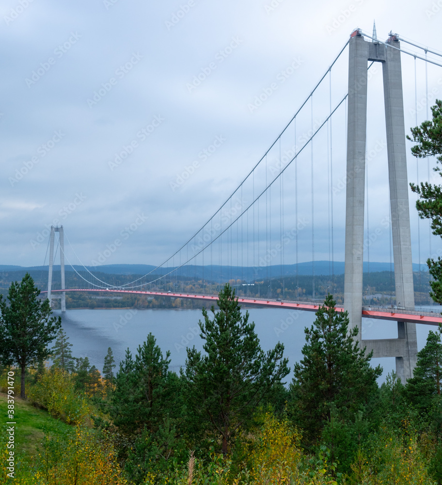 The High Coast Bridge in Sweden. It is a suspension bridge over the Angerman river between Kramfors and Harnosand municipalities in Adalen. The High Coast Bridge in Sweden. It is a suspension bridge over the Angerman river between Kramfors and Harnosand municipalities in Adalen.