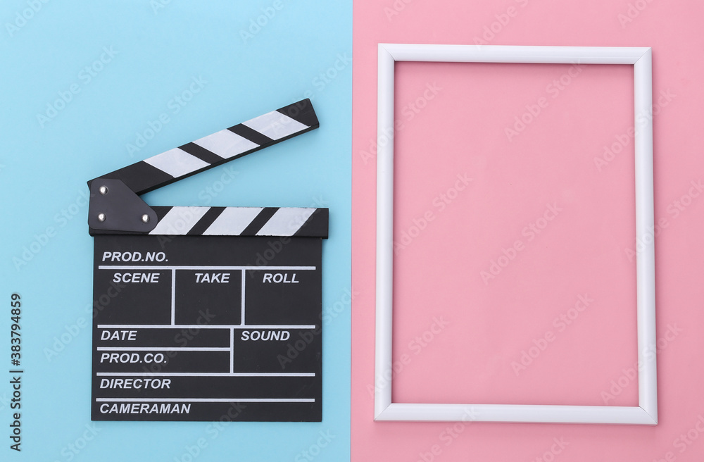 Film clapper board with white frame for copy space on pink blue pastel background. Cinema industry, entertainment. Top view