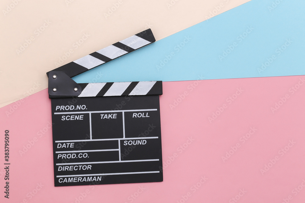 Movie clapper board on colored pastel background. Cinema industry, entertainment. Top view