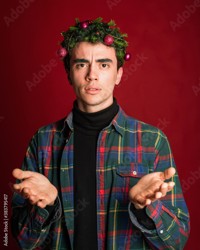 attractive man in a plaid shirt on a red background hair like a christmas tree christmas mood copyspace