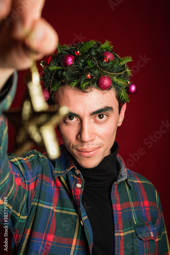 attractive man in a plaid shirt on a red background hair like a christmas tree christmas mood copyspace