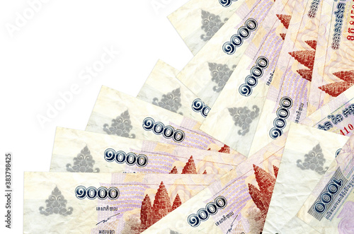 1000 Cambodian riels bills lies in different order isolated on white. Local banking or money making concept photo