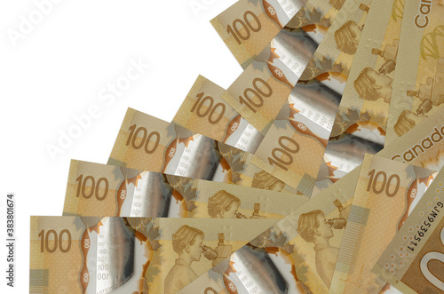 100 Canadian dollars bills lies in different order isolated on white. Local banking or money making concept photo