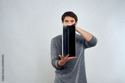 man holding laptop technology internet work communication light background